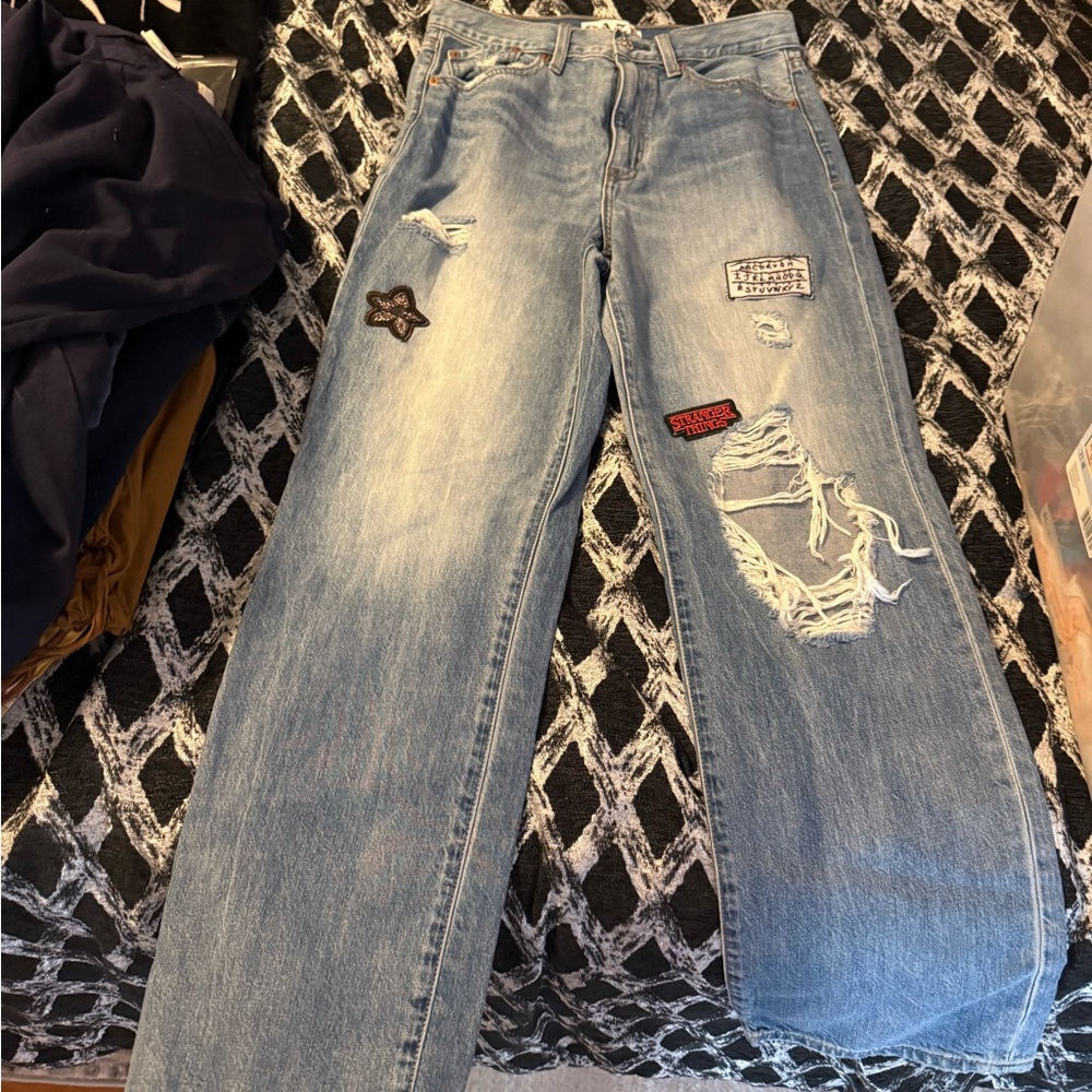 Distressed Light Blue Jeans with Patches